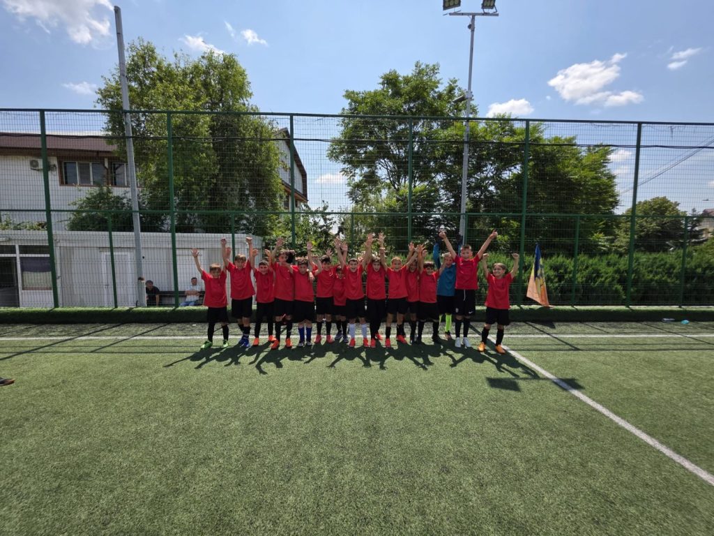 Fotografie de grup cu ACS Unirea Dobroești Grupa 2015–2016 alături de părinți și antrenori, zâmbind după un meci de succes în turneul Liga de Copii.