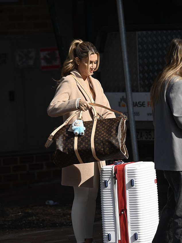 Bride Drama Unfolds at Married At First Sight Australia 5 Gia showed off her ample cleavage in a low-cut white top paired with leggings and a long camel coat as she helped the driver remove her bags from the car boot