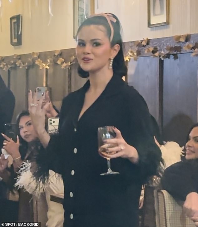 Gomez dressed for the occasion wearing black pajama bottoms with a feathery hem as well as a matching top